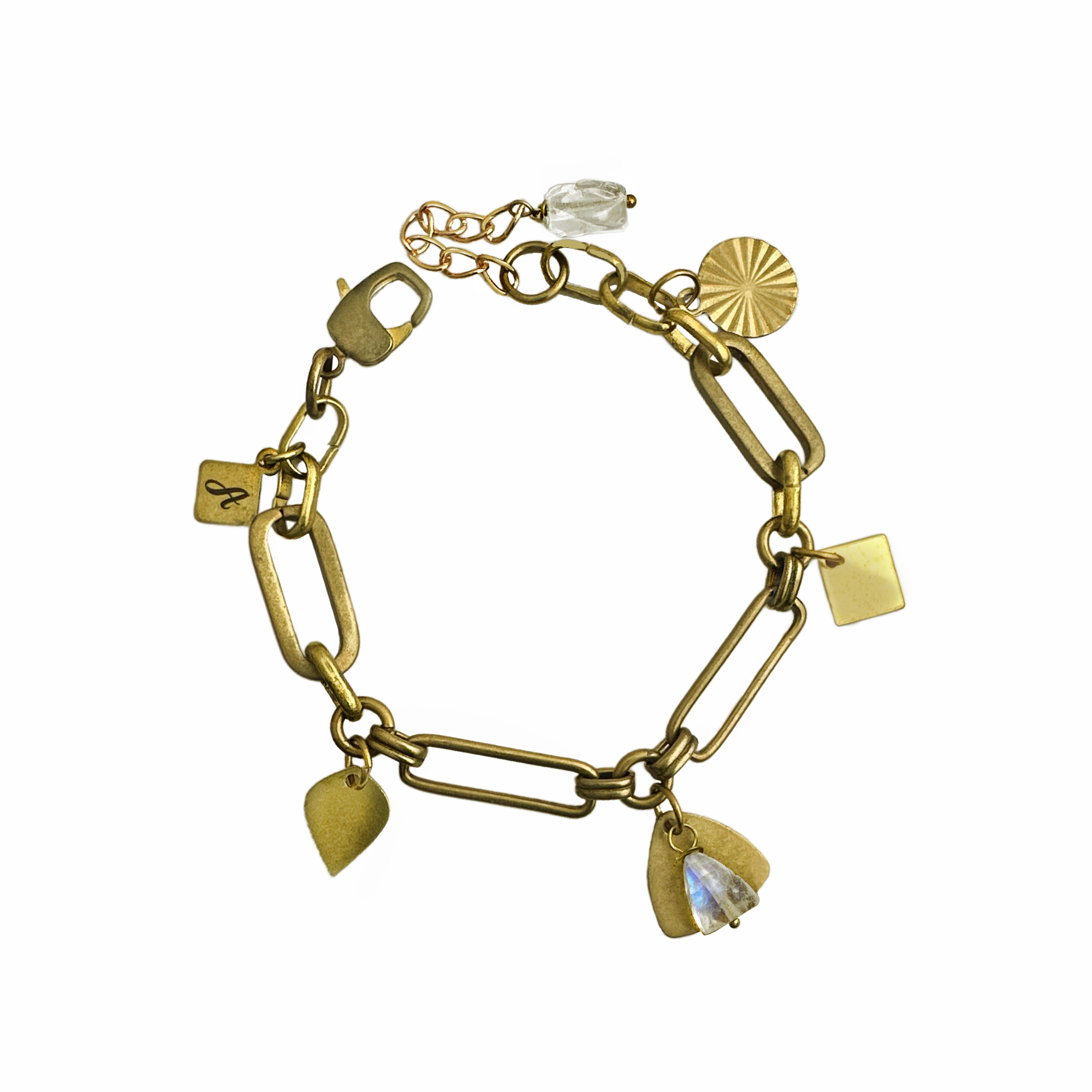A brass bracelet with sleek vintage links, geometric charms, a rainbow moonstone gemstone drop and crystal quartz nugget. Handcrafted by Alysian.