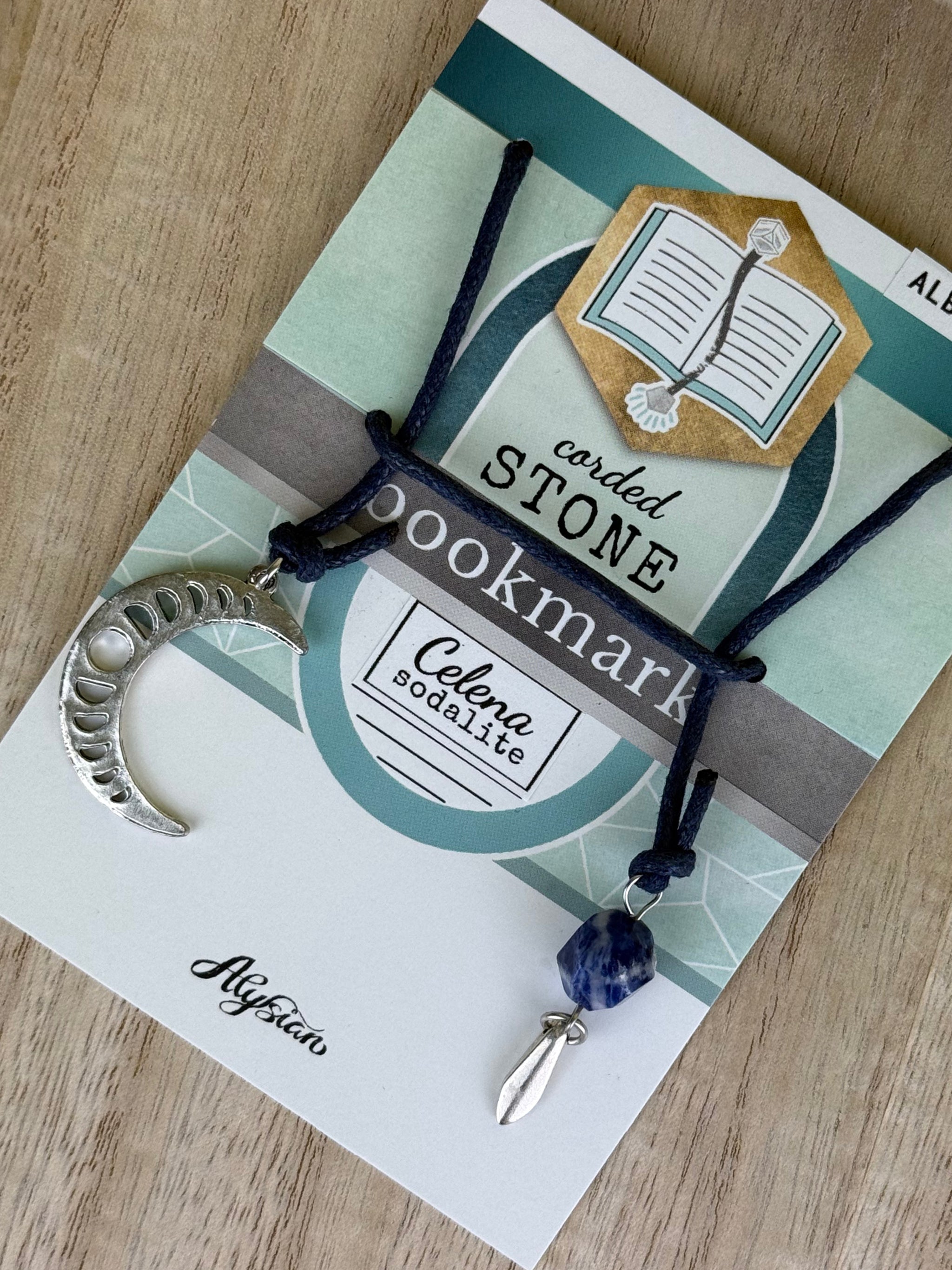 Handcrafted Celena Sodalite Bookmark with a silver crescent moon and a sodalite stone charm on a branded card.
