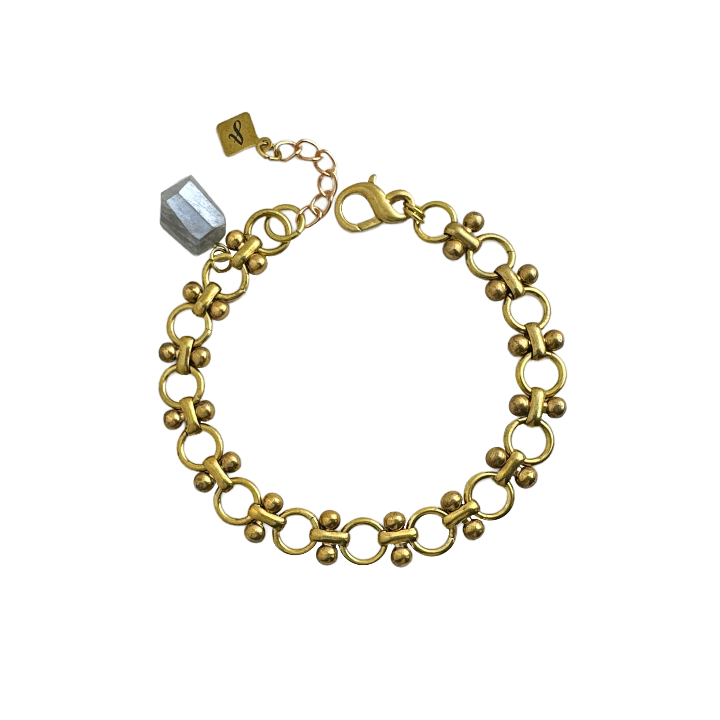 A gold-colored bracelet with a vintage bowdoin link design and a gray moonstone nugget, displayed against a white background. 