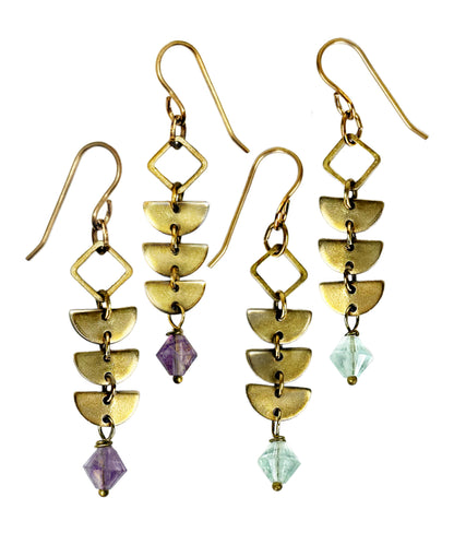 Two pairs of brass Alune Fluorite Earrings shown with green fluorite and also in purple fluorite. Handcrafted by Alysian.