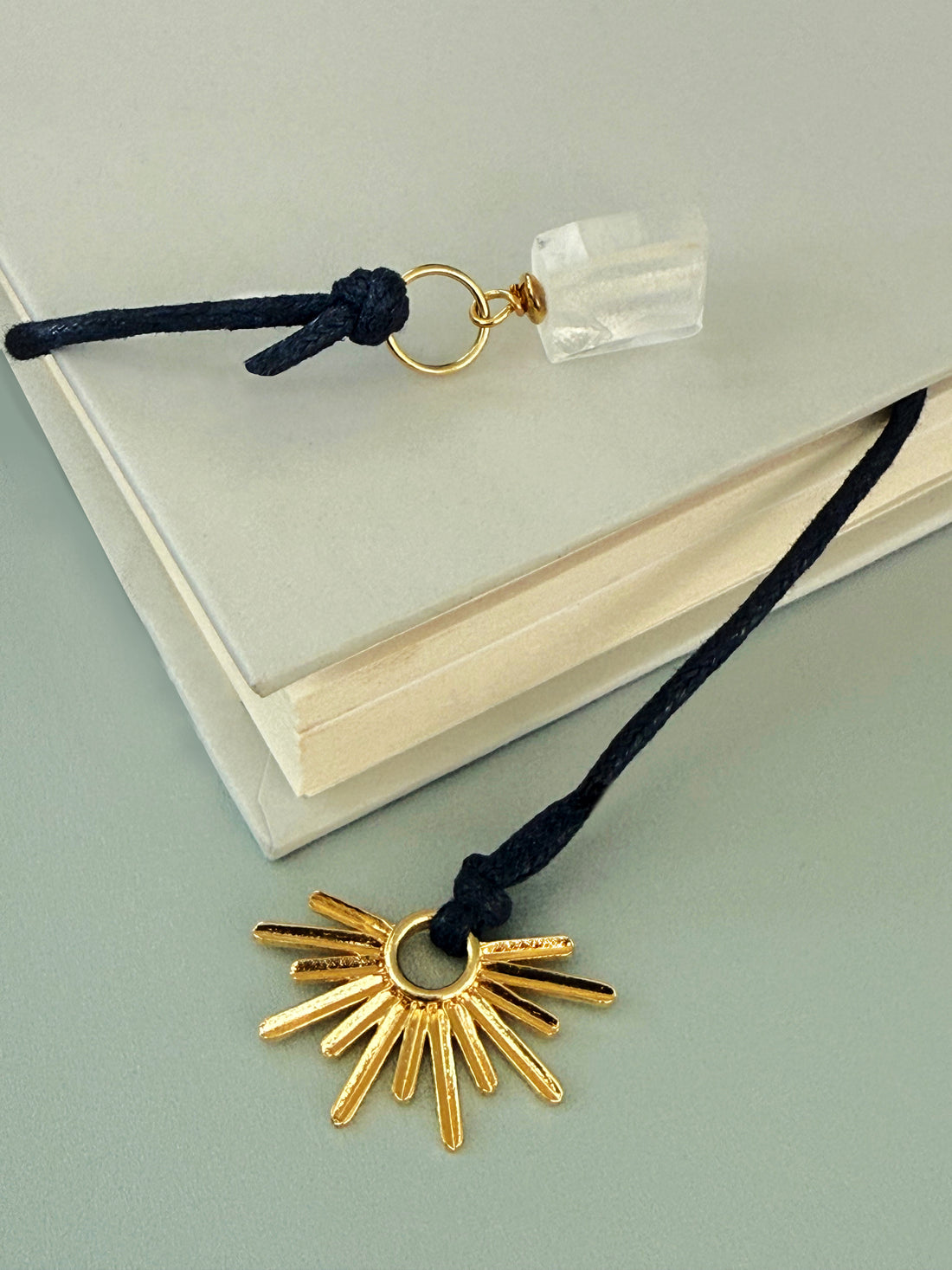 Asura Raw Quartz Bookmark – A handcrafted bookmark by Alysian placed in a book.