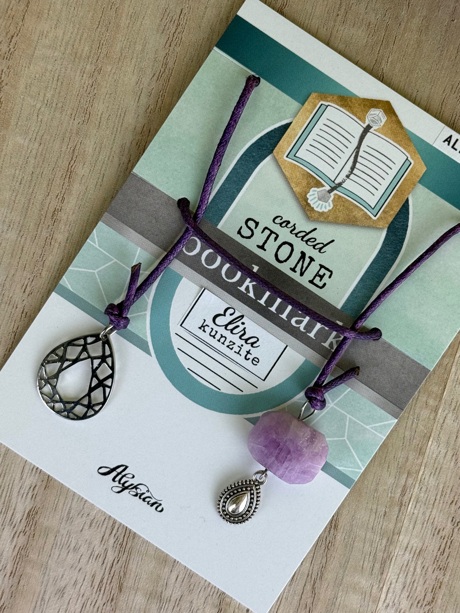Elira Kunzite Bookmark on a branded card