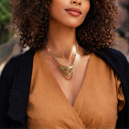 Woman wearing the Alysian adjustable Lusine pendant necklace at a short length.