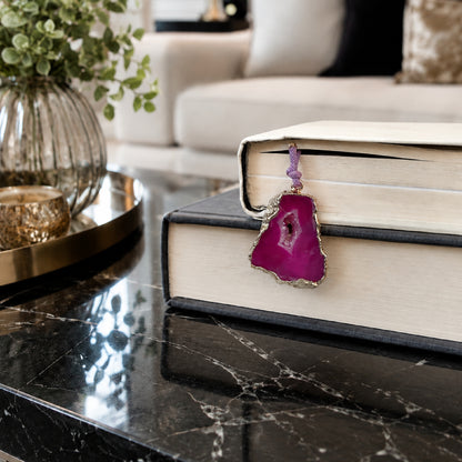 Serra Geode Bookmark – Fuchsia – A handcrafted bookmark by Alysian on a coffee table in a living room.