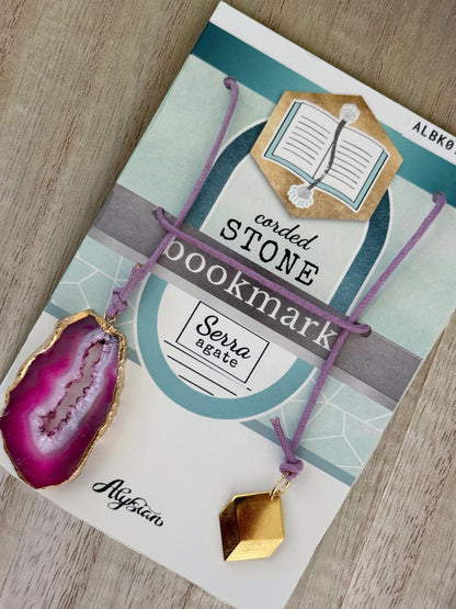 Sierra fuschia geode stone bookmark on Alysian card packaging on a wooden surface.
