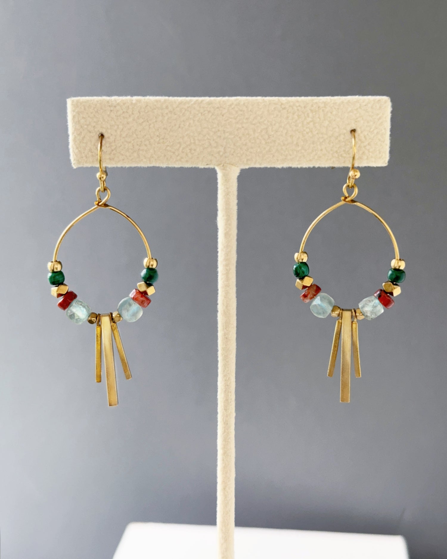 Brass hoop earrings with green malachite, sesame jasper and aqua apatite stones,  and edgy brass fringe on an earring stand — Soren apatite hoop by Alysian.