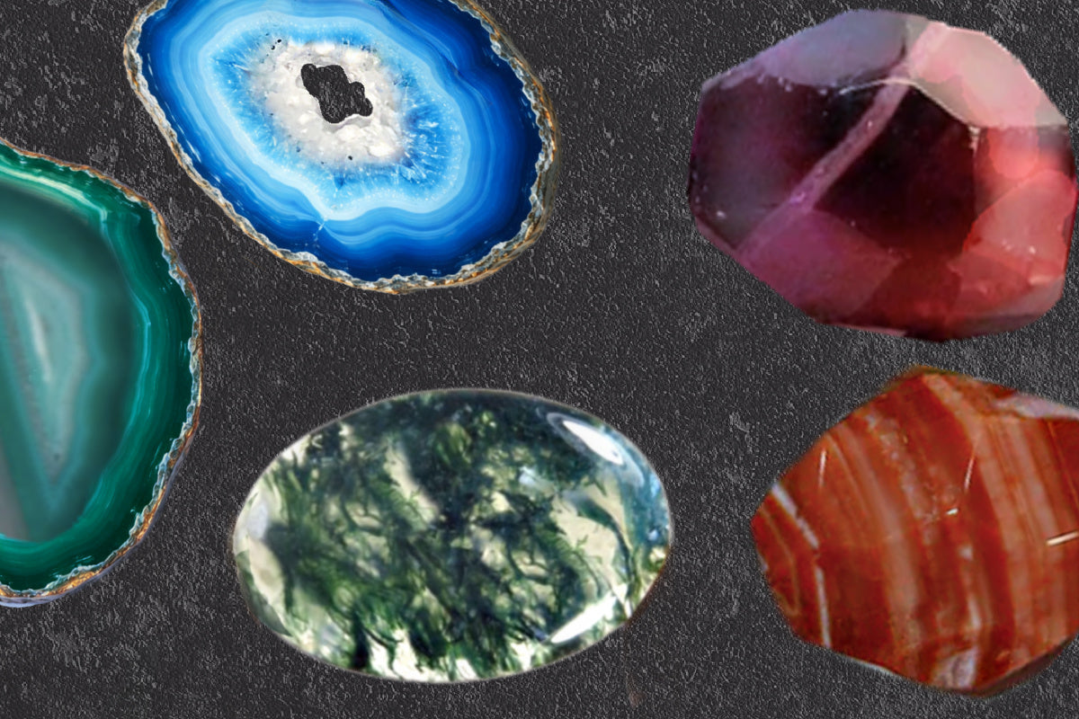 A display of richly colored agate stones on a dark surface, each with natural variations.