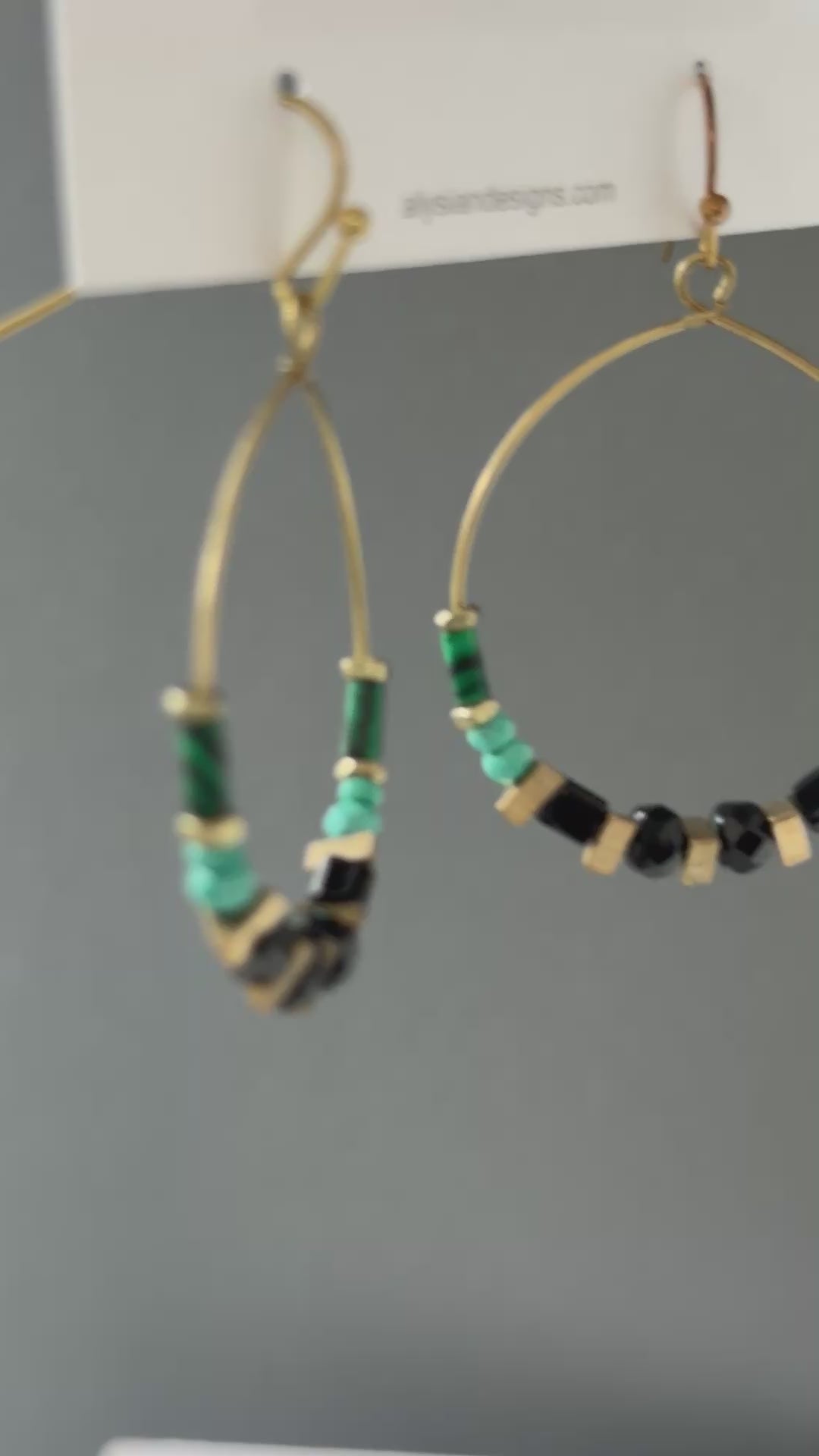 A video of Alysian Adira Hoop Earrings close up with gemstones, vintage jet crystal and brass accents shimmering.