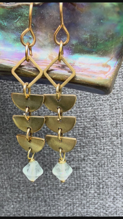 A pair of brass Alune Fluorite Earrings shown with green fluorite. Handcrafted by Alysian.
