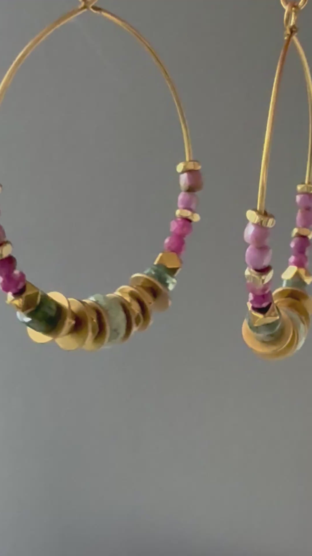 A video of Alysian Mirelle Multistone Hoop Earrings close up with gemstones and brass accents shimmering.